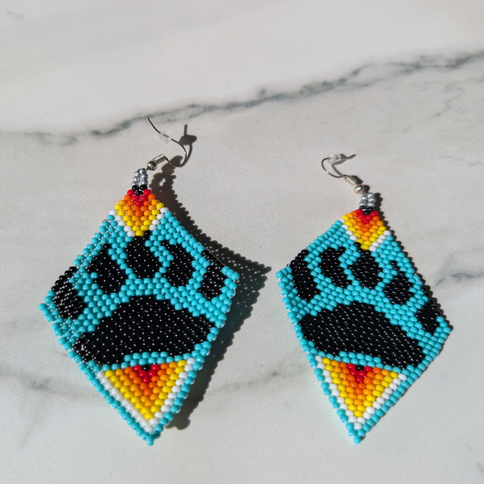 Pair of beaded earrings with bear paw design