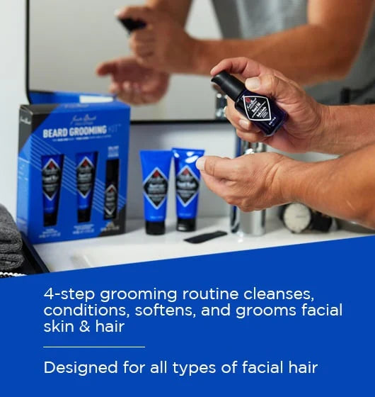 Person holding a beard grooming product with a display of related items on a counter.