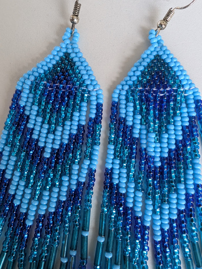 close up of top of blue beaded earrings