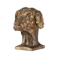 A decorative dog sculpture with an antique gold and bronze finish.