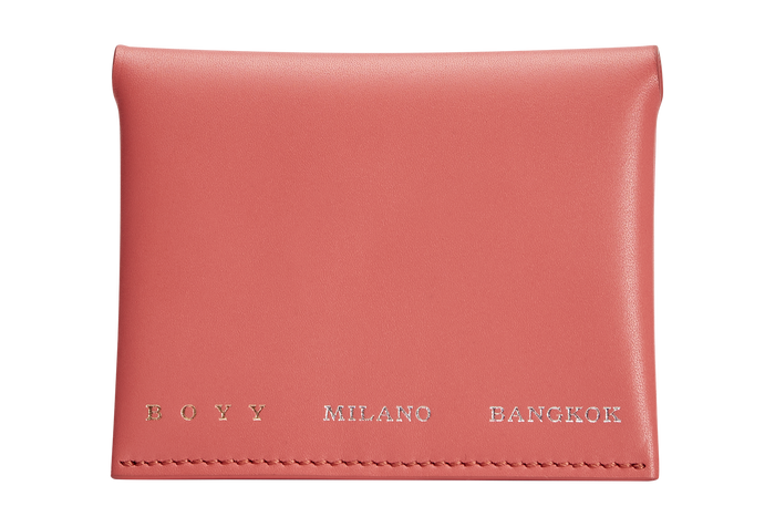 A coral red box calf leather card holder with grey goat skin lining, featuring two internal slots and a snap closure, made from a single piece pattern. The text “BOYY MILANO BANGKOK” is embossed in gold and silver on the front
