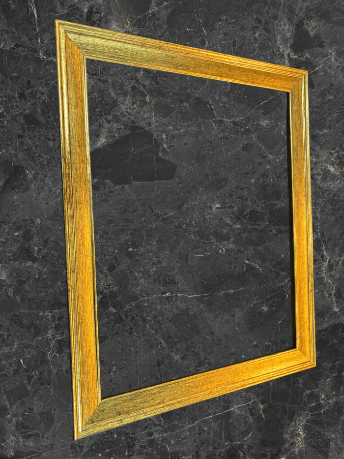 Gold picture frame on a black marble surface