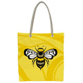 Yellow tote bag with a bee design by Indigenous artist  Adam Lewis