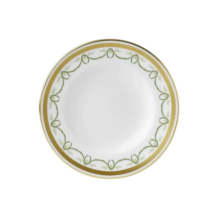 White plate with gold and green decorative rim on a white background