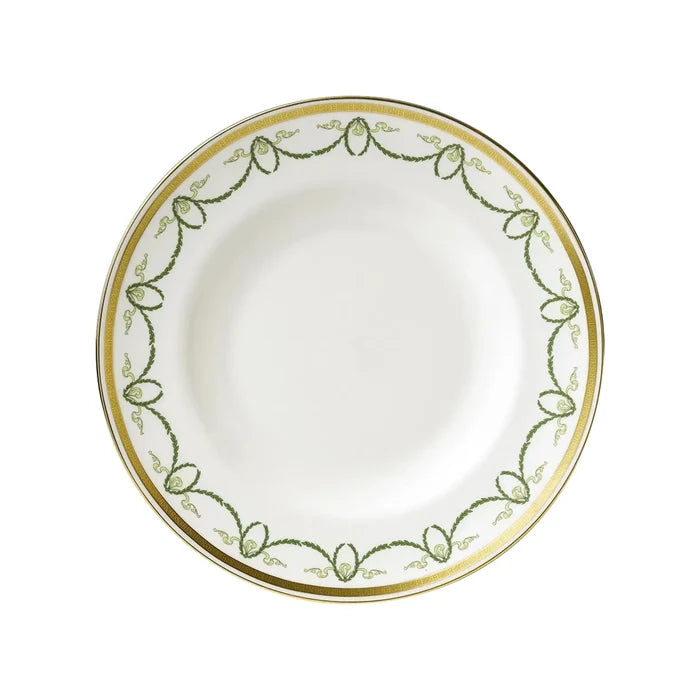 White plate with green and gold decorative rim on a white background