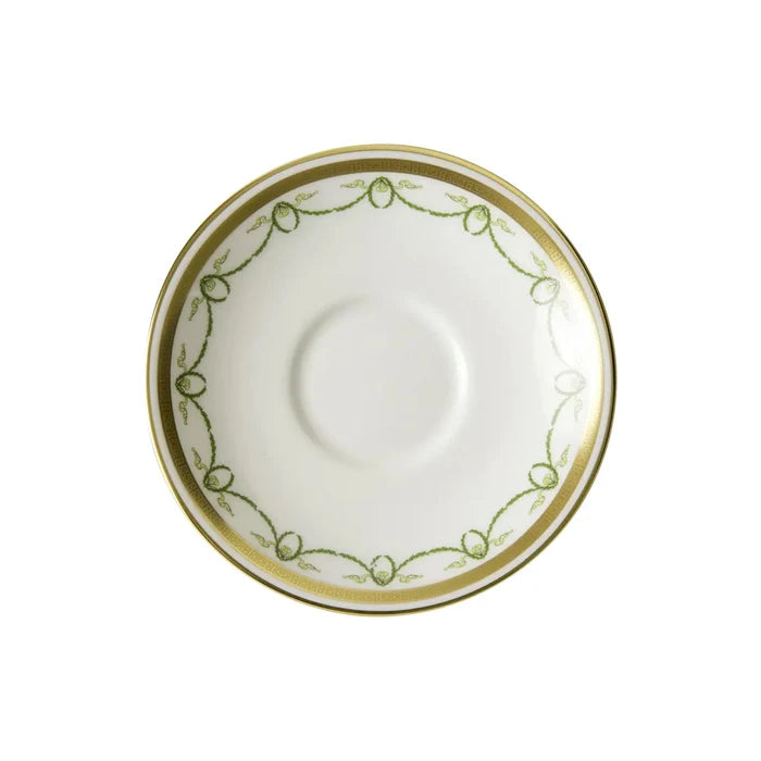 White saucer with gold and green decorative rim on a white background